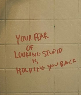 Your fear of looking stupid is holding you back. Graffiti quote on titles.